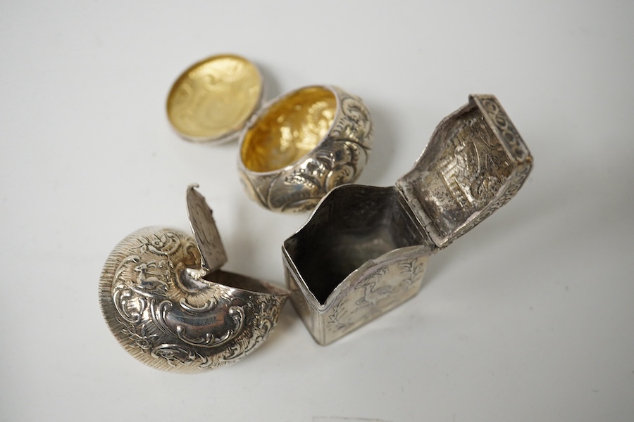 Three small silver boxes, including late Victorian modelled as a snail shell, import marks for London, 1898?, one modelled as a miniature cabinet, makers mark only and a late Victorian circular pill box. Condition - fair